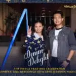 Employee smiling and posing in casual denim attire during Virtua's year-end celebration, showcasing a cheerful team moment.