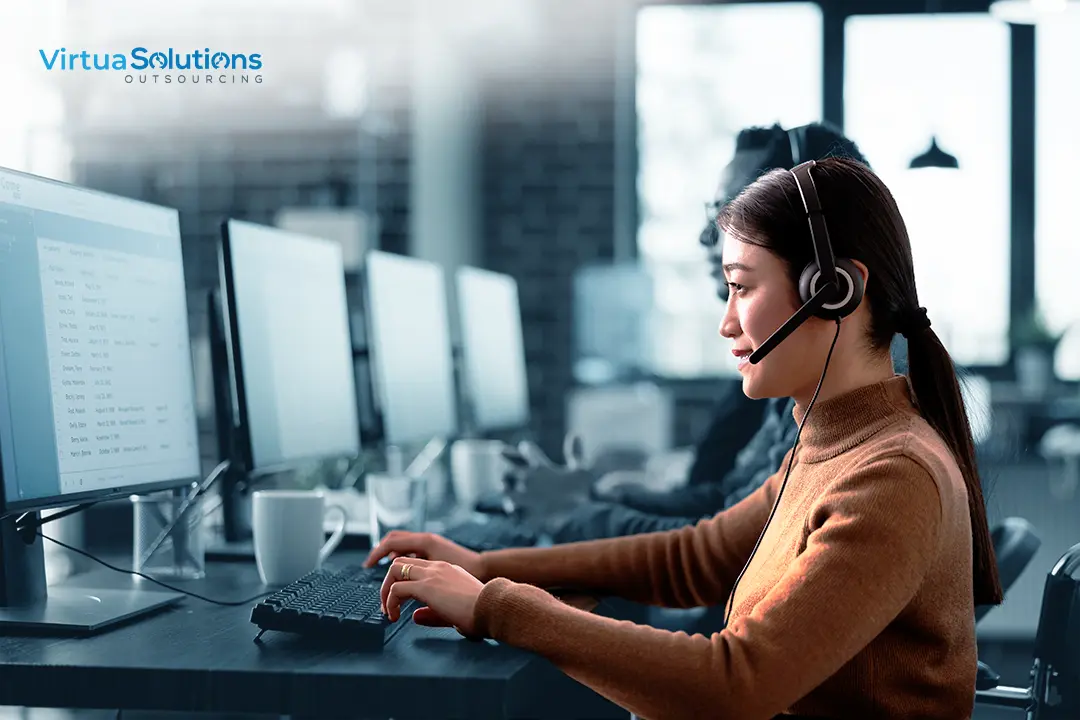 professional in front of a computer screen wearing a headset